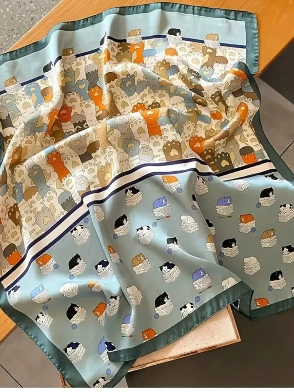Playful Cat Paw Scarf in Orange & Navy feels like silk is polyester
